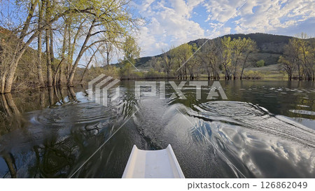 rowing scenery from a calm lake at foothills of Rocky Mountains - rower POV view rowing scenery from a calm lake at foothills of Rocky Mountains - rower POV view 126862049