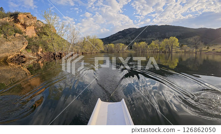 rowing scenery from a calm lake at foothills of Rocky Mountains - rower POV view 126862050