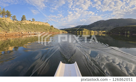 rowing scenery from a calm lake at foothills of Rocky Mountains - rower POV view rowing scenery from a calm lake at foothills of Rocky Mountains - rower POV view 126862051