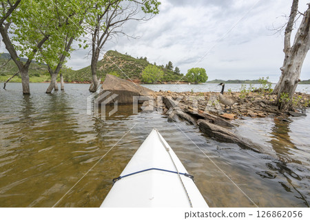 spring kayaking or canoeing on Horsetooth Reservoir at foothills of Rocky Mountains near Fort Collins, Colorado - POV paddler perspective spring kayaking or canoeing on Horsetooth Reservoir at foothills of Rocky Mountains near Fort Collins, Colorado - POV paddler perspective 126862056