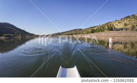morning rowing on calm water of Horsetooth reservoir in Colorado - POV rower perspective 126862088