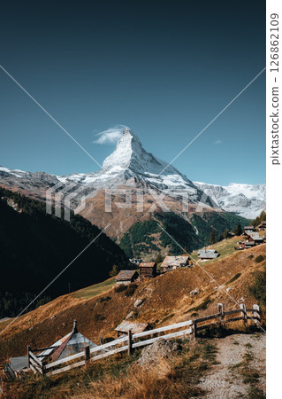 Matterhorn mountain among Swiss Alps with rustic village on hill in sunny day 126862109