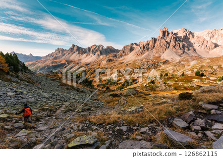Rocky mountain summit with hiker hiking in autumn wilderness at Claree Valley, France 126862115