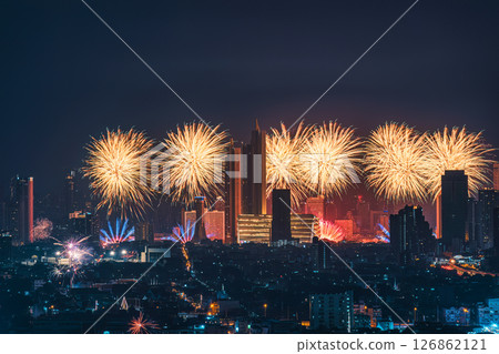 New year festival with firework display glowing over department store, illuminated building 126862121