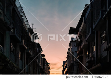 Old townhouse buildings with balcony and evening sky in suburban Old townhouse buildings with balcony and evening sky in suburban 126862128