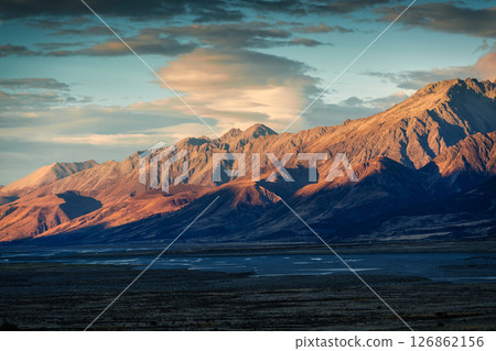 Golden sunrise over rugged rocky mountain range in autumn at New Zealand 126862156