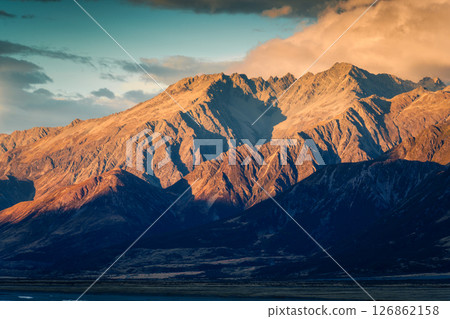 Golden sunrise over rugged rocky mountain range in autumn at New Zealand 126862158