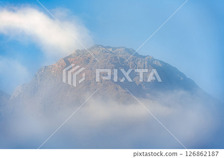 Mountain peak with blue sky and wispy cloud 126862187