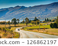 Scenic rural road trip with winding road, mountain, sheep farm and lake during autumn at New Zealand 126862197