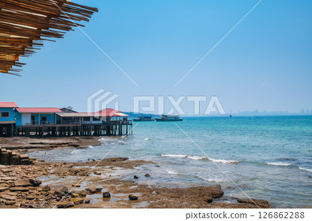 Fishing village built on tropical sea and ferry boat by the dock in summer at Koh Larn island Fishing village built on tropical sea and ferry boat by the dock in summer at Koh Larn island 126862288