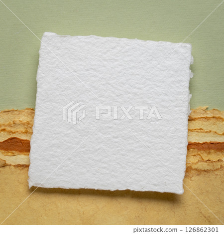 small blank sheet of watercolor paper on a tan toned paper small blank sheet of watercolor paper on a tan toned paper 126862301