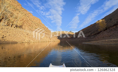 rowing on calm water of sandstone canyon of Horsetooth reservoir in Colorado - POV rower perspective rowing on calm water of sandstone canyon of Horsetooth reservoir in Colorado - POV rower perspective 126862328