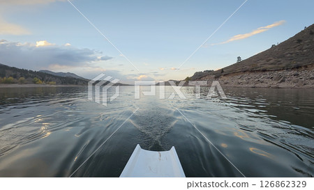 dusk rowing on calm water of Horsetooth reservoir in Colorado - POV rower perspective dusk rowing on calm water of Horsetooth reservoir in Colorado - POV rower perspective 126862329