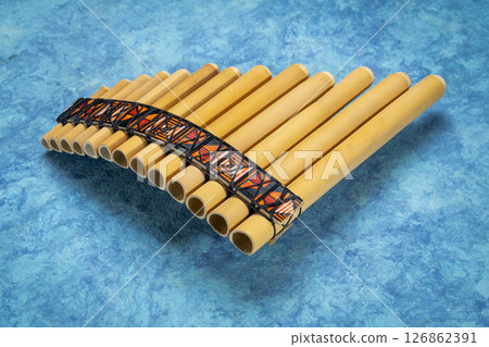 bamboo pan flute instrument from Peru against textured art paper bamboo pan flute instrument from Peru against textured art paper 126862391