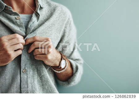 Man Unbuttoning Linen Shirt in Minimalist Setting 126862839