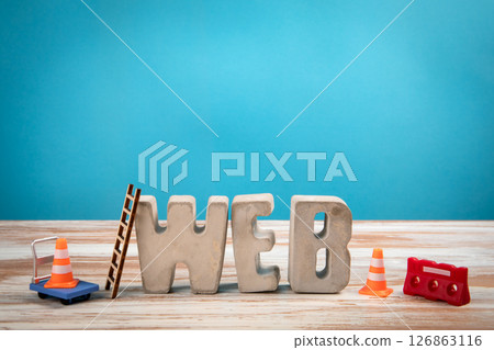 WEB Concept. Concrete Alphabet Letters on a White Wooden and Blue Background 126863116