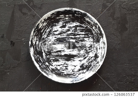 Empty black plate on wooden table. Food background for menu. Flatlay, top view. 126863537