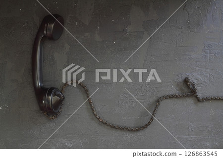 black old telephone receiver hanging on black background with texting space, waiting for phone call black old telephone receiver hanging on black background with texting space, waiting for phone call 126863545
