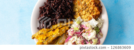 A wholesome and savory breakfast with brown rice and baked white fish, complemented by zucchini-carrot pancakes and a fresh Chinese cabbage salad with radish, banner 126863609