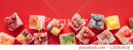 Ice cubes with frozen berries and fruits Ice cubes with frozen berries and fruits 126863626