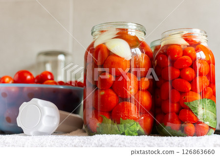 Homemade tomato preserves and tomato juice, canned and sealed for winter storage, maintaining flavor and freshness Homemade tomato preserves and tomato juice, canned and sealed for winter storage, maintaining flavor and freshness 126863660