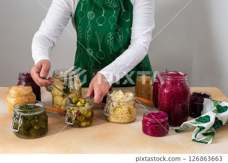 Woman fermenting fresh vegetables 126863663
