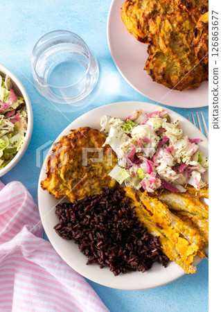 A wholesome and savory breakfast with brown rice and baked white fish, complemented by zucchini-carrot pancakes and a fresh Chinese cabbage salad with radish A wholesome and savory breakfast with brown rice and baked white fish, complemented by zucchini-carrot pancakes and a fresh Chinese cabbage salad with radish 126863677