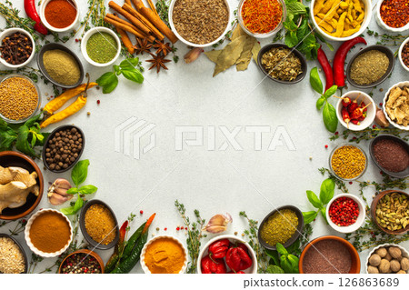 Fresh and colorful spices and herbs arranged in a frame on a gray background, adding natural beauty and culinary charm, top view and copy space Fresh and colorful spices and herbs arranged in a frame on a gray background, adding natural beauty and culinary charm, top view and copy space 126863689