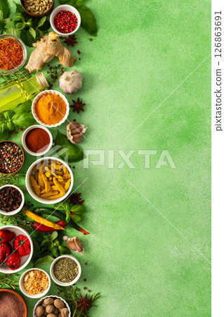 Fresh, fragrant spices and herbs arranged in an array of colors, sitting on a soft green backdrop, bringing flavor and zest to any kitchen, top view and copy space Fresh, fragrant spices and herbs arranged in an array of colors, sitting on a soft green backdrop, bringing flavor and zest to any kitchen, top view and copy space 126863691