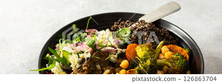 A vibrant, protein-packed breakfast with black quinoa, avocado, chicken, roasted veggies like sweet potato, broccoli, and a fresh salad of cabbage, radish, chia, and sesame seeds, banner 126863704