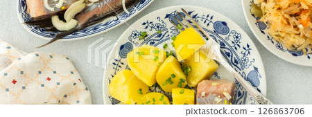 Boiled potatoes with pickled herring and sauerkraut Boiled potatoes with pickled herring and sauerkraut 126863706