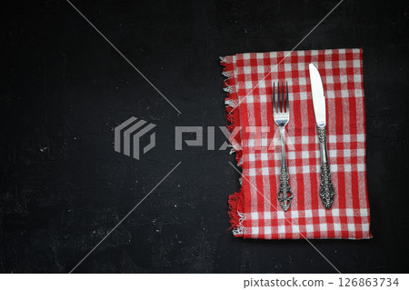 Overhead shot of silverware on black table with copy space. 126863734