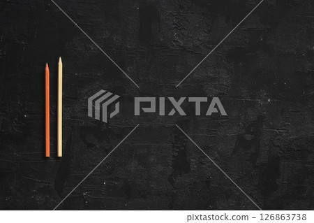 Lots of pencils on black board background with copy space. Back to school concept. Flat lay. Lots of pencils on black board background with copy space. Back to school concept. Flat lay. 126863738