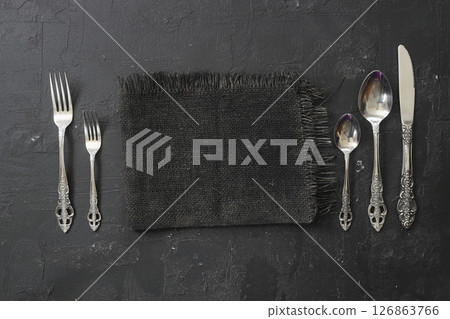 Overhead shot of silverware on black table with copy space. 126863766