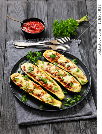 stuffed zucchini boats filled with bolognese sauce 126863938