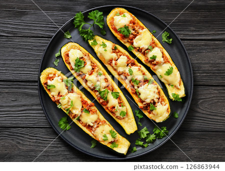 stuffed zucchini boats filled with bolognese sauce 126863944