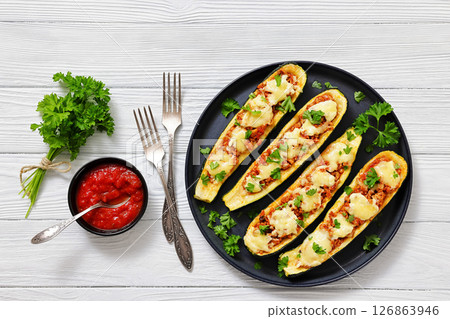 stuffed zucchini boats filled with bolognese sauce 126863946