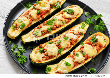 stuffed zucchini boats filled with bolognese sauce 126863948