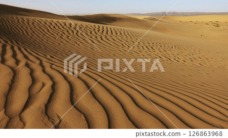 Sand blowing over sand dunes in wind Sand blowing over sand dunes in wind 126863968