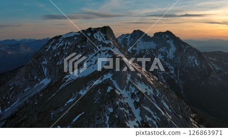 Rocky snow mountains at sunset aerial Rocky snow mountains at sunset aerial 126863971