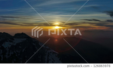 Rocky snow mountains at sunset aerial Rocky snow mountains at sunset aerial 126863978