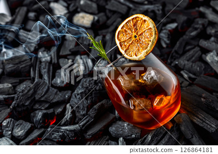 Old-fashioned cocktail with ice, dried orange slice, and rosemary. Old-fashioned cocktail with ice, dried orange slice, and rosemary. 126864181