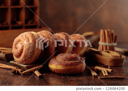 Swedish cinnamon rolls on a brown background. 126864200