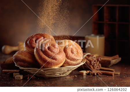 Swedish cinnamon buns are sprinkled with cinnamon powder. 126864202