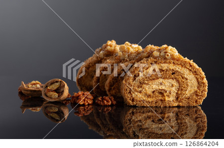 Dessert with walnuts on a black reflective background. Dessert with walnuts on a black reflective background. 126864204