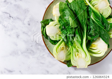 Boiled bok choy, cut on a plate, top view, no people, 126864324