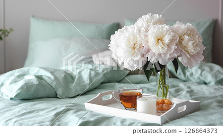 Huge white peonies bouquet and white wooden tray with hot black tea, 126864373