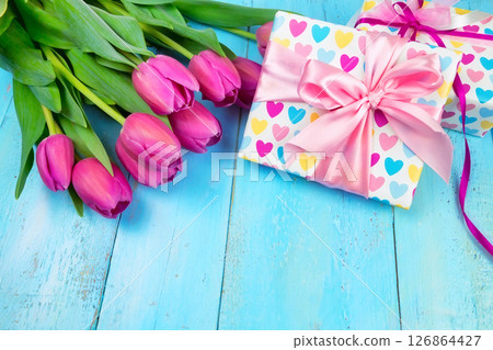 Spring background. Bouquet of flowers on a wooden background and a nest with eggs. spring Spring background. Bouquet of flowers on a wooden background and a nest with eggs. spring 126864427