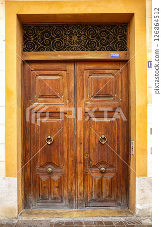Intricately Designed Wooden Double Door in a Historic Building in a Picturesque Neighborhood 126864512