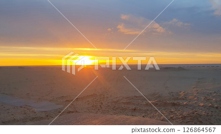 Man alone and beautiful evening sunset by the beach. Sunrise at sea. Ostende, Belguim 126864567